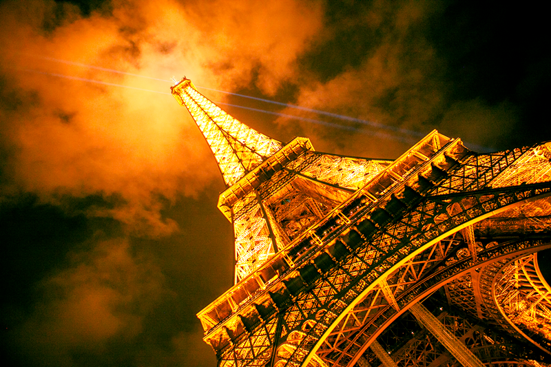 Eiffel Tower with it's beaming lights at night in Paris