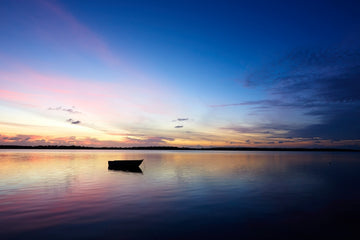 Lone Boat At Sunrise
