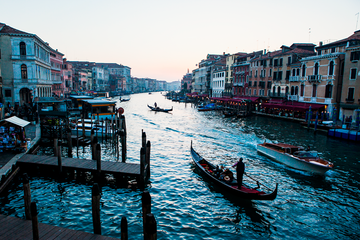 Sunset in Venice featuring a strem of boats and gondola