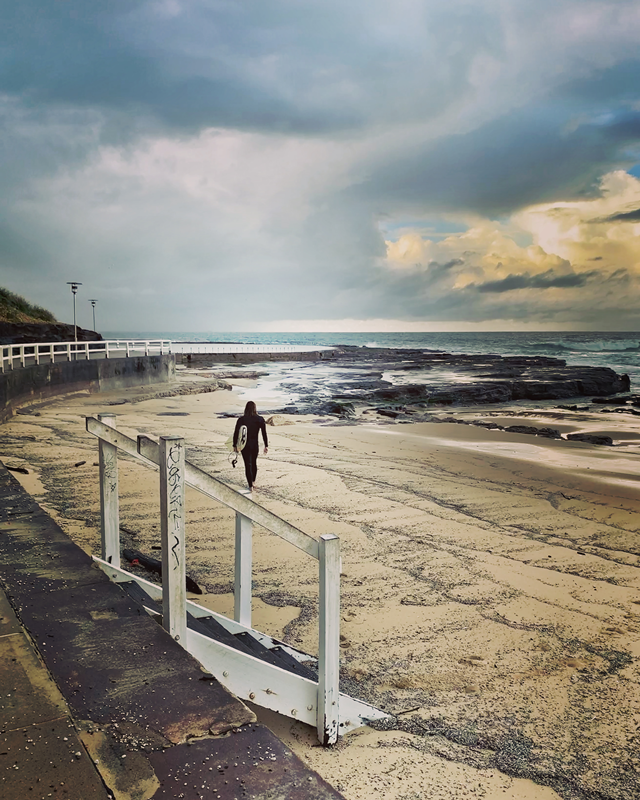 surfer heading to the waves