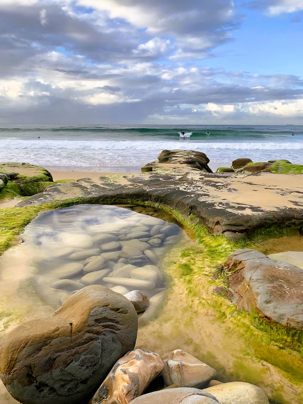 two surfers and rockpool